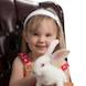 Easter Special: child in brown chair with bunny